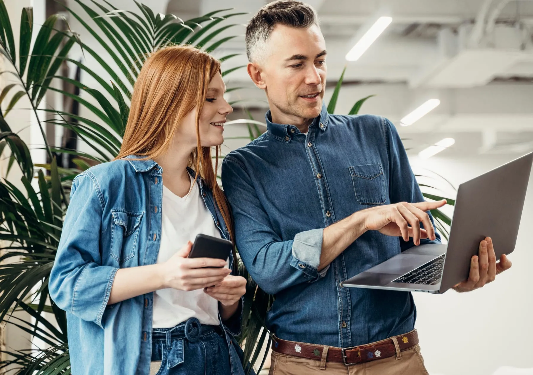 Man showing something laptop his coworker