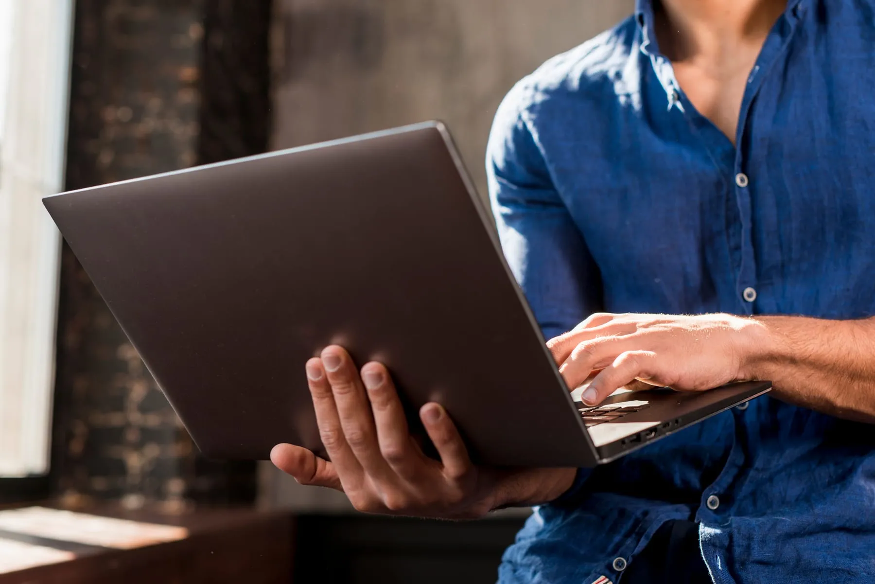 Close up young man using laptop hand