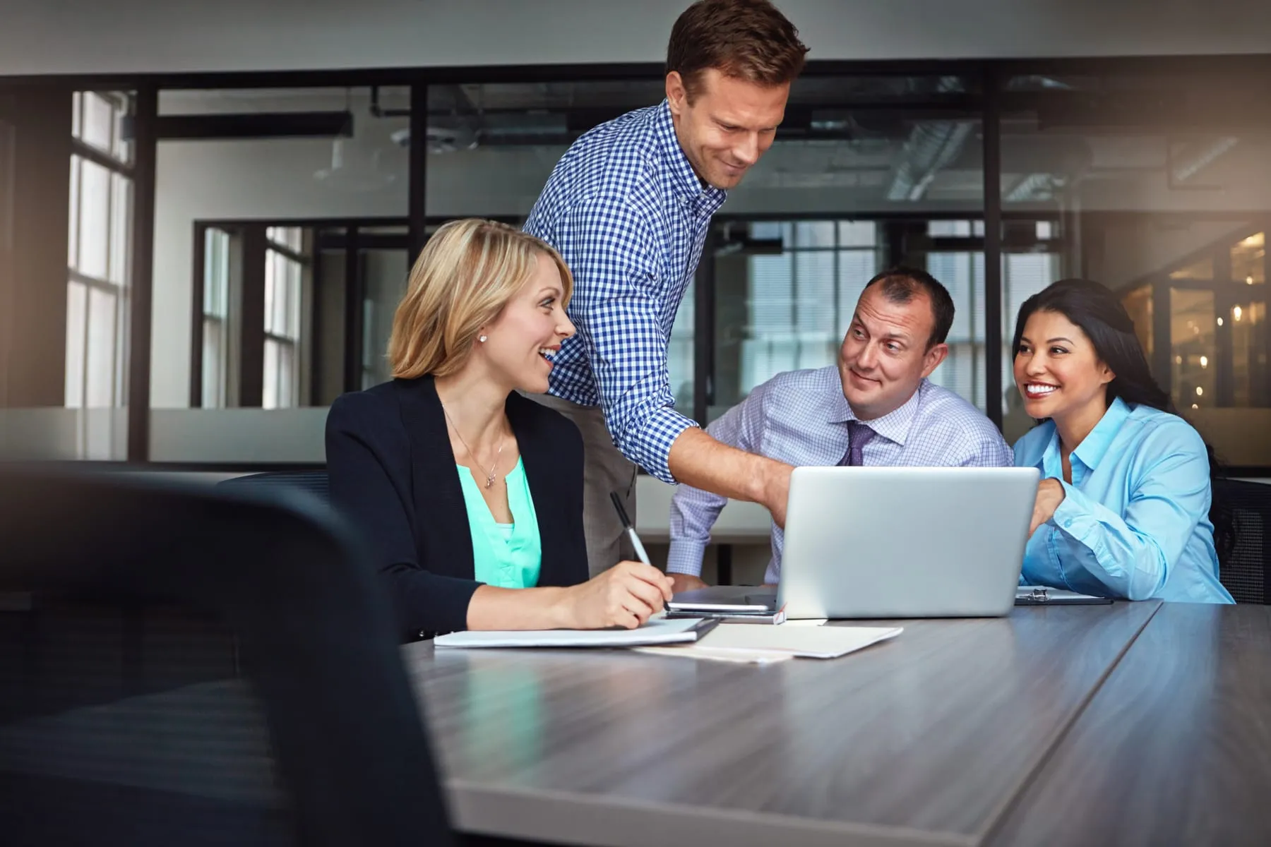 Happy laptop business people meeting conversation brainstorming with research corporate update software web designer group employees with computer