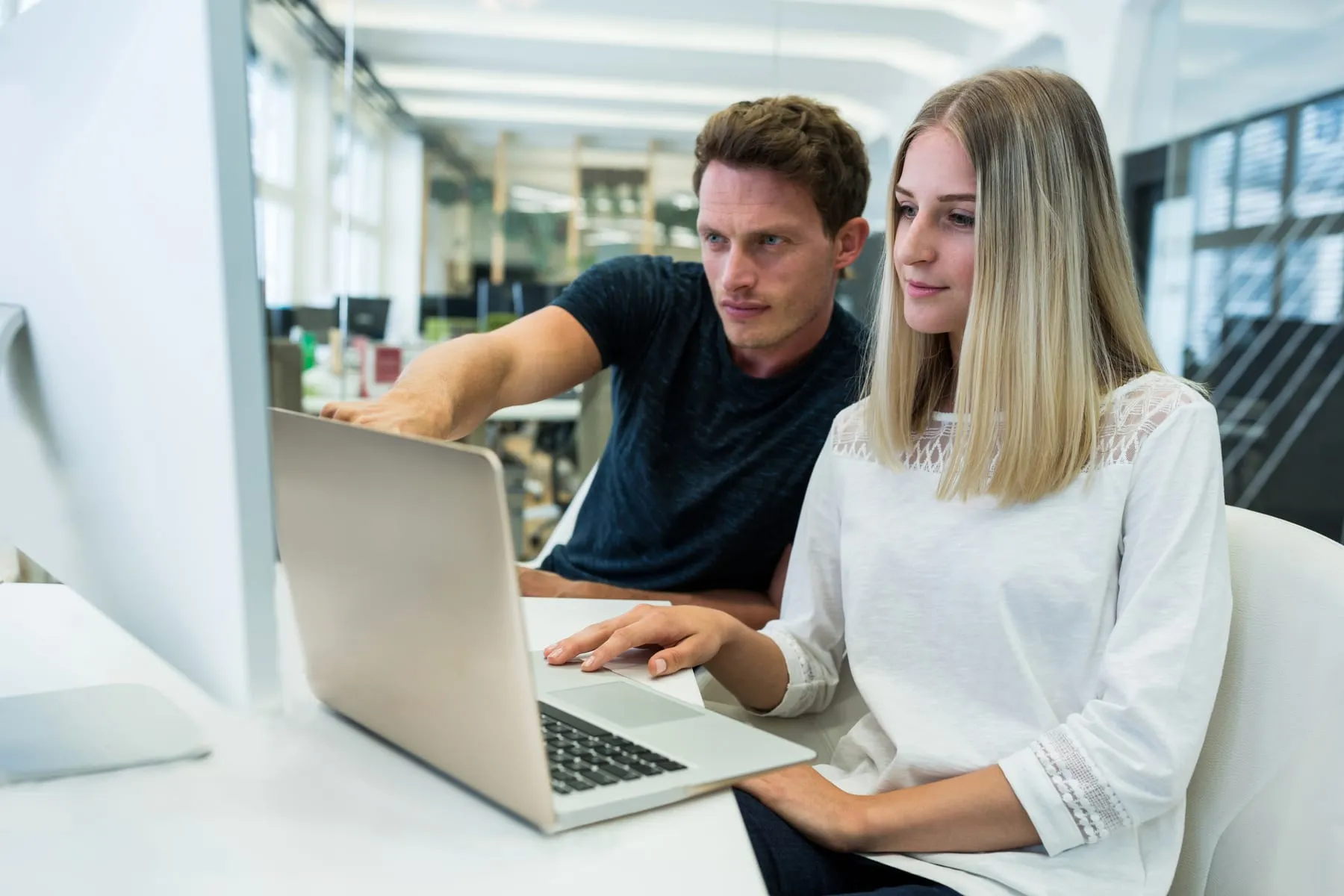 Male female graphic designers interacting with each other
