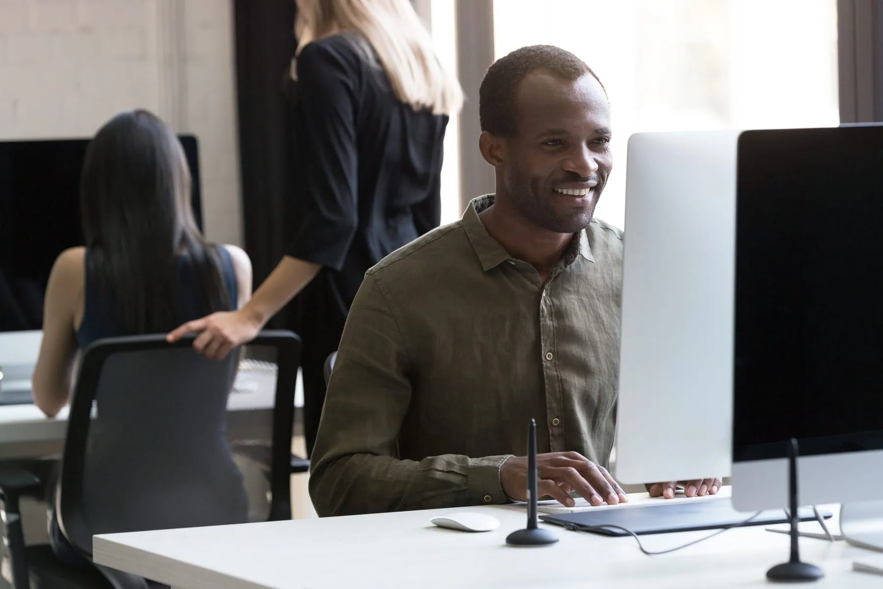 Smiling african american businessman working his computer